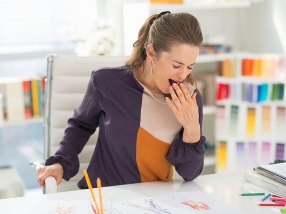 Woman feeling tired at work - Eating to Boost Energy